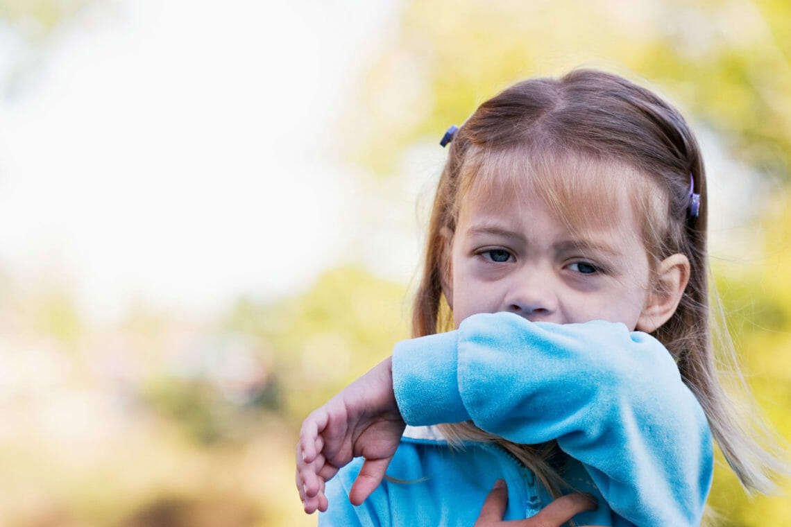 Photo of young girl with whooping cough coughing fit