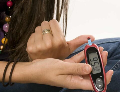 photo of woman using diabetic self test strip