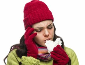 photo of a woman with head cold and tissue