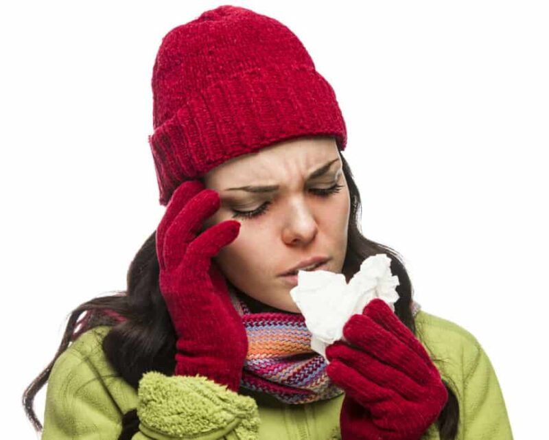 photo of a woman with head cold and tissue