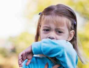 Young girl with whooping cough coughing